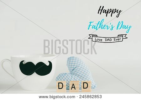 Happy Fathers Day Concept. Handmane Red Heart With Mustache And Bow Tie On Coffee Cup With Wooden Bl