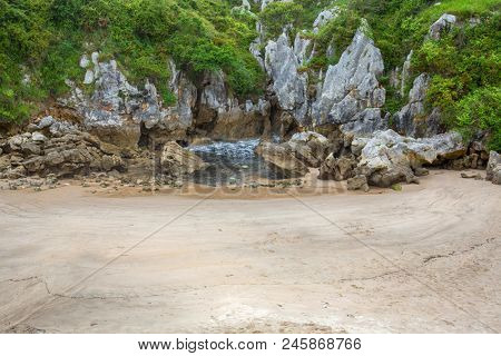 the famous beach gulpiyuri, in Asturias, Spain