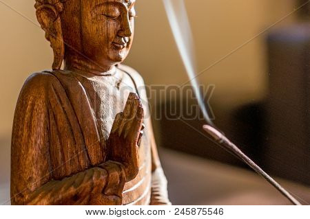 Buddha Wooden Statue On A Yellow Background