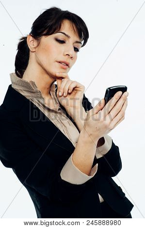 Young Caucasian Brunette Suit Dressed Business Woman Chatting With A Vintage Smartphone. Standing Up