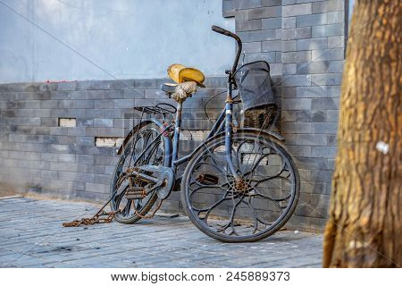 Beijing, China - March 10, 2016: Bicycles, Scooters And Cars In Beijing Streets.
