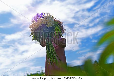 A Bouquet Of Flowers In The Hands Of A Little Girl. A Child With Flowers. Flowers For Mom.