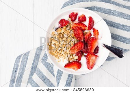 Healthy Breakfast With Granola, Yoghurt And Strawberry On The Table With Napkin. Top View With Place