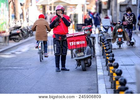 Beijing, China - March 10, 2016:  Food Delivery Courier With Scooters Brought Orders To Customers.