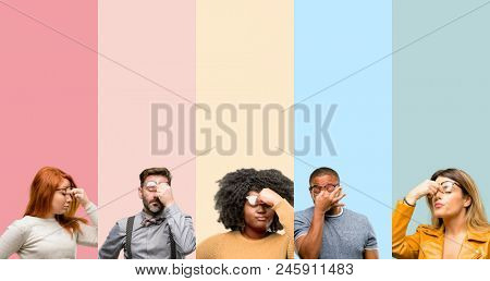 Cool group of people, woman and man with sleepy expression, being overworked and tired, rubbes nose because of weariness