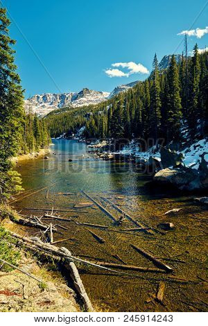 Lake Verna with rocks and mountains around at autumn. Rocky Mountain National Park in Colorado, USA. 