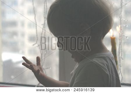 The Naughty Little Boy Touched The Candle Fire, Now His Hand Hurts. It Hurts To The Boy, He Cries An