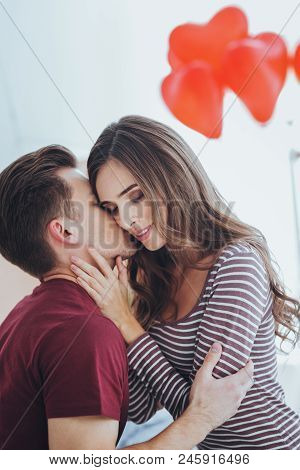 True Feelings. Pleasant Young Man Kissing His Girlfriend While Expressing His Feelings