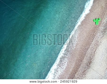Aerial View Turquois Water Of Ionian Sea In Albania, Stones On Shore And Giant Inflated Cactus Top V