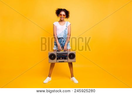 Full Size Portrait Of Fancy Pretty Girl In Jeans Jumpsuit Sneakers Eyewear Holding Boom Box With Cas