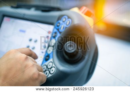 Engineer Hand Point At Control Button Of Robot To Control In The Factory. Use Smart Robot In Manufac