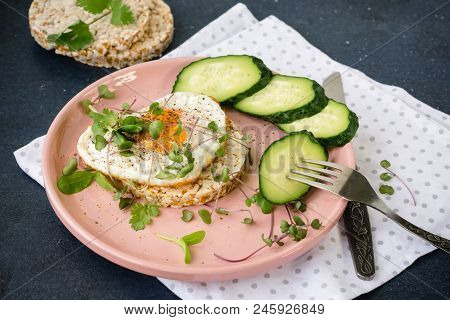 Breakfast Fried Egg, Micro Greens And Bread On A Pink Plate.