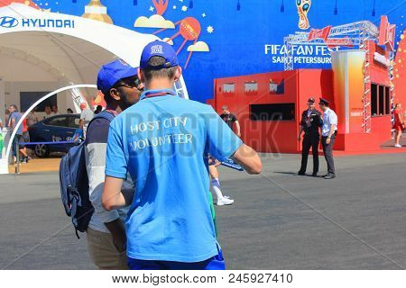 St. Petersburg, Russia - June 18, 2018: Fifa World Cup Russia 2018 Volunteer Helping A Fan. Male Vol