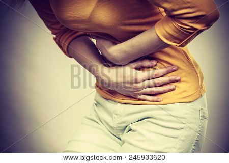 Health Care Concept. Bellyache, Indigestion Or Menstruation. Young Female Suffering From Strong Stom