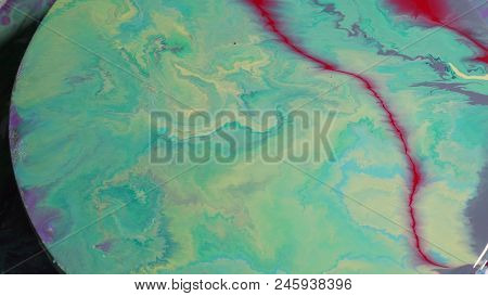 Painted Round Canvas In Green In Fluid Art Style