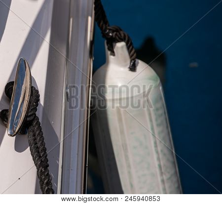 Dock Cleat On The Side Of A Boat In A Small Marina, An Element Of Yachting Equipment