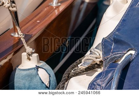 Dock Cleat On The Side Of A Boat In A Small Marina, An Element Of Yachting Equipment