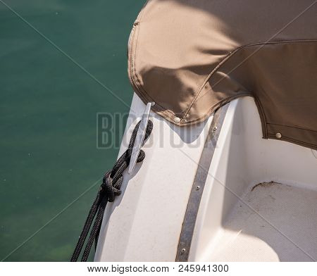 Dock Cleat On The Side Of A Boat In A Small Marina, An Element Of Yachting Equipment