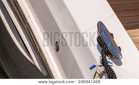 Dock Cleat On The Side Of A Boat In A Small Marina, An Element Of Yachting Equipment