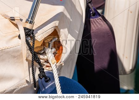 Dock Cleat On The Side Of A Boat In A Small Marina, An Element Of Yachting Equipment