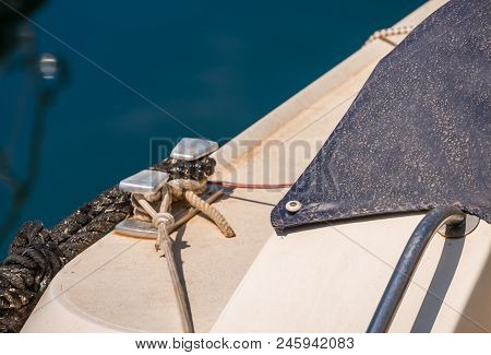 Dock Cleat On The Side Of A Boat In A Small Marina, An Element Of Yachting Equipment