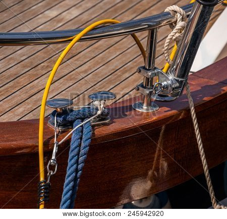 Dock Cleat On The Side Of A Boat In A Small Marina, An Element Of Yachting Equipment