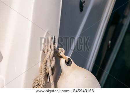 Dock Cleat On The Side Of A Boat In A Small Marina, An Element Of Yachting Equipment