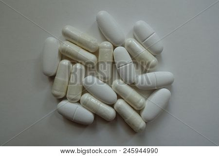 Group Of White Capsules Of Magnesium Citrate And Caplets Of Calcium Citrate