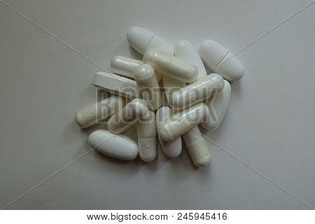 Heap Of White Capsules Of Magnesium Citrate And Caplets Of Calcium Citrate
