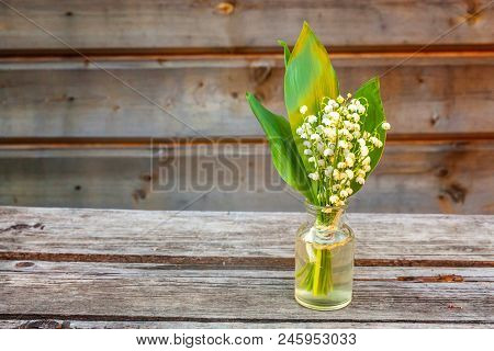 Bouquet Of Flowers Beautiful Smell Lily Of The Valley Or May-lily In Glass Vase On Rustic Old Vintag
