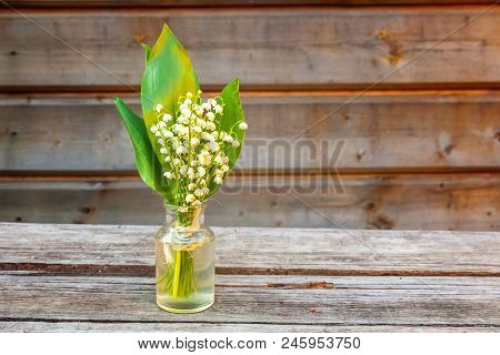 Bouquet Of Flowers Beautiful Smell Lily Of The Valley Or May-lily In Glass Vase On Rustic Old Vintag