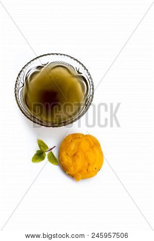 Jaggery Or Gud With Its Syrup In A Transparent Bowl Isolated On White.