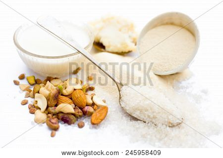Entire Ingredients For Suji Ka Halwa Isolated On White Including Milk And Dry Fruits.