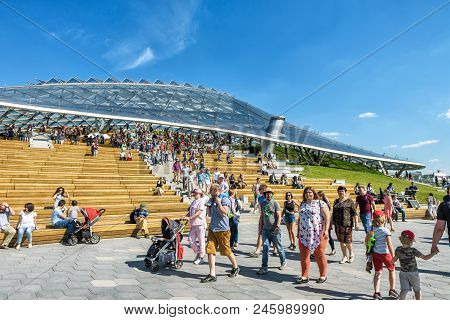 Moscow - June 17, 2018: People Walk Past The Modern Amphitheater With A Glass Roof In Zaryadye Park 