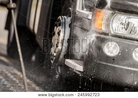Semi Tractor In The Truck Wash Closeup Photo. Taking Care Of The Vehicle.