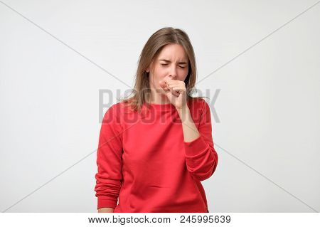 Unhappy Caucasian Woman In Red Pulover Suffering From Throat Pain At Home. Concept Of Being Ill And 
