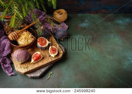 Juicy Fresh Whole Fig Fruits And One Cut Figs And Bowl Of Honey In Honeycombs On Wooden Cutting Boar
