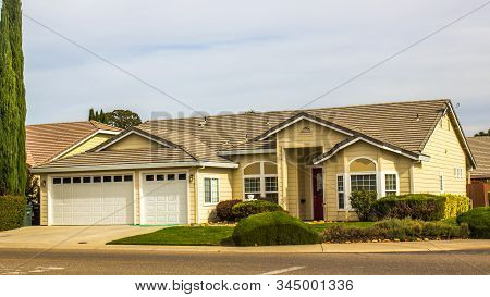 Front Exterior Of Modern One Story Home With Three Car Garage