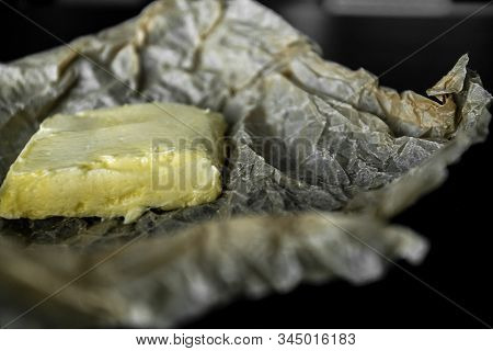 Soft Butter On Wrapper And Black Table