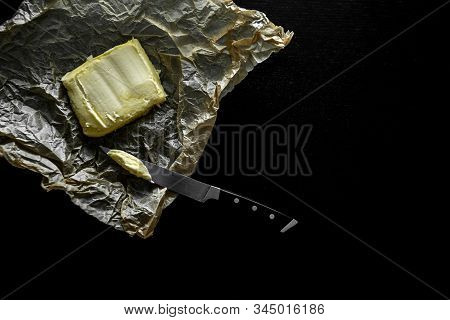 Soft Butter On Wrapper And Black Table