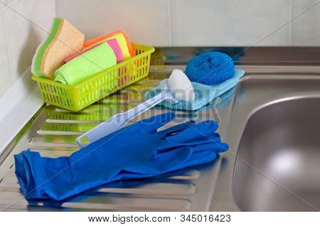 On The Kitchen Sink Are Items For Washing Dishes And Cleaning The Kitchen