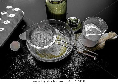 Ingredients For Home Baking: Cookies, Bread, Cake. Flour, Sugar, And Eggs Are On The Black Table. Ba