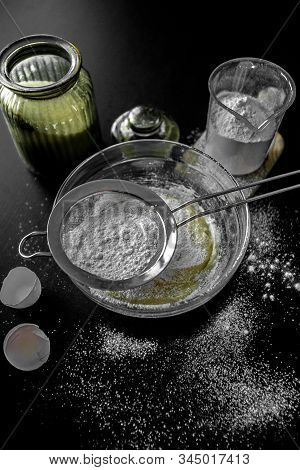 Ingredients For Home Baking: Cookies, Bread, Cake. Flour, Sugar, And Eggs Are On The Black Table. Ba