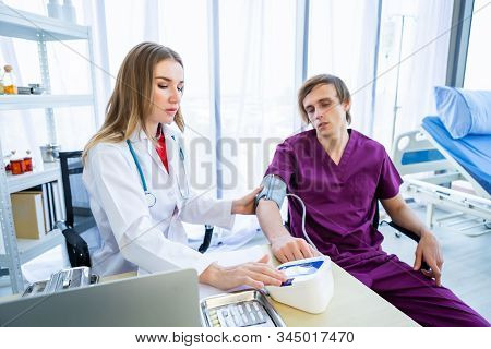 Female Doctor Therapeutic Advising With Positive Emotions To A Man Patient On Bed Abstract Blur With