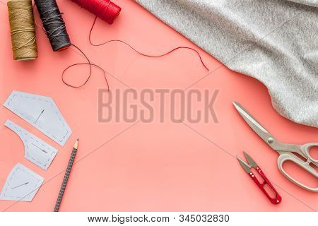 Sewing Wokrshop. Textile, Pattern, Scissors, Thread On Pink Background Top-down Copy Space