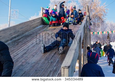 Novokuznetsk, Russia- January 07, 2019: Russian Winter Entertainment: Children Having Fun Tobogganin