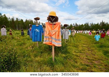 Suomussalmi, Finland - July 24, 2019: View To The Group Of Objects In People Clothes Which Looks Lik