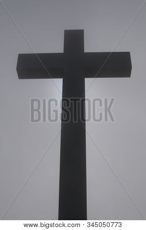 Silhouette Of A Religious Cross In Middle Of The Fog And Located On The Top Of The Mount Lema Peak I