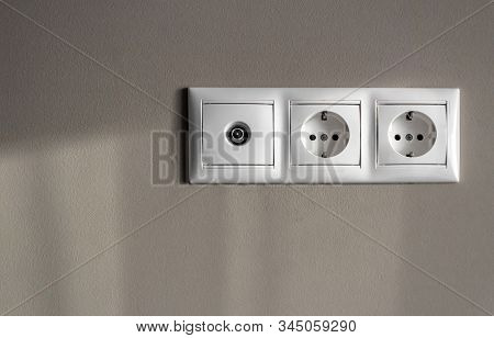 Electrical Outlets, A Set Of Three White Empty Electrical Sockets For Appliances And An Antenna Conn