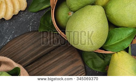 Fresh Peeled Pomelo, Pummelo, Grapefruit, Shaddock On Dark Background In Bamboo Basket. Autumn Seaso